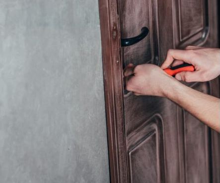 Using a screwdriver to unlock a door