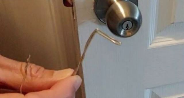 A person unlocking A Deadbolt Lock With Paperclip