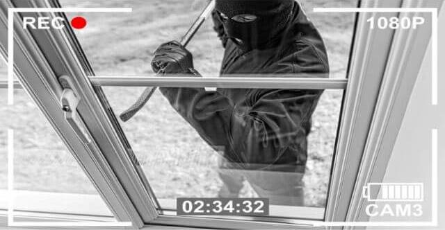 A Burglar Breaking In Through Window