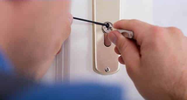A person opening a Deadbolt Door from outside