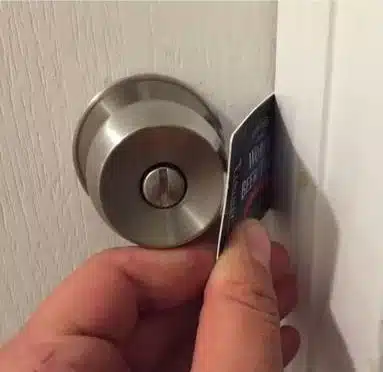 aa person Inserting a card to open a doorknob