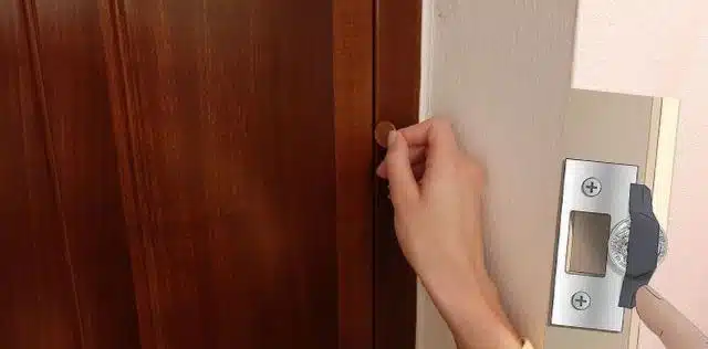 A person Locking A Door With Pennies